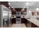 Modern kitchen with dark wood cabinets and stainless steel appliances at 5450 E Deer Valley Dr # 4169, Phoenix, AZ 85054