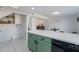 White countertops and green cabinets, along with a dishwasher and a view into the laundry room at 6757 N 44Th Ave, Glendale, AZ 85301