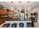 Kitchen boasts a large island with seating, granite countertops and wood cabinetry at 41301 W Sussex Dr, Maricopa, AZ 85138