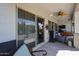 Covered patio with seating area, sliding glass door, and ceiling fan at 41301 W Sussex Dr, Maricopa, AZ 85138
