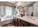 Double vanity bathroom with a soaking tub and shower at 41301 W Sussex Dr, Maricopa, AZ 85138