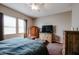 Comfortable bedroom with a queen bed and dresser at 41301 W Sussex Dr, Maricopa, AZ 85138