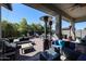 Large covered patio with multiple seating areas and heaters at 41301 W Sussex Dr, Maricopa, AZ 85138