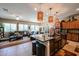 Open kitchen with large island, granite counters, and stainless steel appliances at 41301 W Sussex Dr, Maricopa, AZ 85138