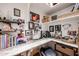 Well-lit home office features built-in shelving and a workspace at 41301 W Sussex Dr, Maricopa, AZ 85138