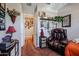 Spacious bedroom with leather recliner and access to hallway at 41301 W Sussex Dr, Maricopa, AZ 85138