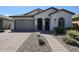 Single-story home with a gray garage door and landscaped front yard at 41301 W Sussex Dr, Maricopa, AZ 85138
