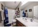 Bathroom featuring a tub shower combo, vanity, and white sink at 41301 W Sussex Dr, Maricopa, AZ 85138