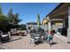 Patio with seating area, fire pit, and outdoor dining table at 41301 W Sussex Dr, Maricopa, AZ 85138