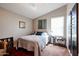 Bedroom with a queen bed, ceiling fan, and decorative wall art at 41301 W Sussex Dr, Maricopa, AZ 85138