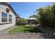 Small backyard with artificial turf, gravel border, and desert plants at 41301 W Sussex Dr, Maricopa, AZ 85138