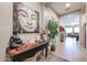 Entryway with decorative console table, large artwork, and view to living room at 41301 W Sussex Dr, Maricopa, AZ 85138