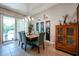 Bright dining room with wood table, teal chairs, and access to backyard at 41301 W Sussex Dr, Maricopa, AZ 85138