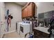 Laundry room with washer, dryer, and ample storage at 41301 W Sussex Dr, Maricopa, AZ 85138