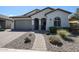 Single-story home with gray exterior, paved driveway, and landscaping at 41301 W Sussex Dr, Maricopa, AZ 85138