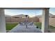 Covered patio with seating area, artificial turf, and putting green at 40968 W Crane Dr, Maricopa, AZ 85138