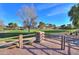 Landscaped park with a wooden fence and stone pillars at 40968 W Crane Dr, Maricopa, AZ 85138