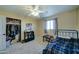 Bedroom with twin bed, ceiling fan, and built-in shelving at 18827 E Via Del Jardin --, Queen Creek, AZ 85142