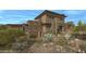 Desert contemporary home with stone accents and expansive windows at 39494 N 105Th St # 74, Scottsdale, AZ 85262