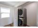 Laundry room with modern stacked washer and dryer at 9901 W Raintree Dr, Sun City, AZ 85351