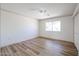 Well-lit bedroom with wood-look floors and a ceiling fan at 9901 W Raintree Dr, Sun City, AZ 85351