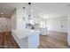 Modern kitchen with white cabinets, quartz counters, and stainless steel appliances at 9901 W Raintree Dr, Sun City, AZ 85351