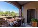 Private patio with wooden table and chairs, offering an outdoor dining space at 5450 E Deer Valley Dr # 2206, Phoenix, AZ 85054