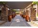 Community walkway with stone pillars and large pots at 5450 E Deer Valley Dr # 2206, Phoenix, AZ 85054