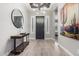 Bright entryway with wood-look floors, a stylish console table, and large artwork at 28001 N 92Nd Ave, Peoria, AZ 85383
