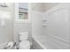 Clean bathroom with toilet, bathtub, and window at 28001 N 92Nd Ave, Peoria, AZ 85383
