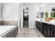 Bathroom with double vanity, soaking tub, and walk-in closet at 28001 N 92Nd Ave, Peoria, AZ 85383