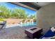 Relaxing backyard oasis with a sparkling pool and fire pit at 28001 N 92Nd Ave, Peoria, AZ 85383
