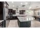 Modern kitchen with curved island, stainless steel appliances, and granite countertops at 28001 N 92Nd Ave, Peoria, AZ 85383