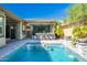 Stunning backyard oasis with a refreshing pool, covered patio, and outdoor kitchen at 28001 N 92Nd Ave, Peoria, AZ 85383