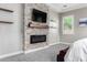 Bedroom with stone fireplace, TV mount, and carpet flooring at 28001 N 92Nd Ave, Peoria, AZ 85383