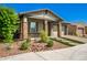 Single-story home with stone accents and a landscaped front yard at 28001 N 92Nd Ave, Peoria, AZ 85383