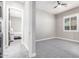 Simple bedroom with grey carpet and view into another bedroom at 28001 N 92Nd Ave, Peoria, AZ 85383