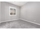 Simple bedroom with grey carpet and window with shutters at 28001 N 92Nd Ave, Peoria, AZ 85383