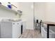 Bright laundry room with washer, dryer, and folding counter at 28001 N 92Nd Ave, Peoria, AZ 85383