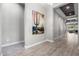 Bright entryway with wood-look floors and large artwork leading to the living room at 28001 N 92Nd Ave, Peoria, AZ 85383