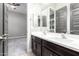 Double vanity bathroom with dark brown cabinets at 28001 N 92Nd Ave, Peoria, AZ 85383