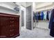 Walk-in closet with custom shelving and dresser at 28001 N 92Nd Ave, Peoria, AZ 85383