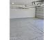 Garage interior with epoxy flooring and overhead storage at 22325 N 78Th Dr, Peoria, AZ 85383