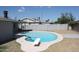 Kidney shaped pool with diving board in backyard at 6604 W Vogel Ave, Glendale, AZ 85302