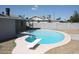 Kidney shaped pool with diving board in backyard at 6604 W Vogel Ave, Glendale, AZ 85302