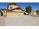 Two-story house with tan exterior, two-car garage, and landscaped yard at 26028 N 66Th Dr, Phoenix, AZ 85083