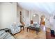 Living room with hardwood floors, comfortable seating, and view of kitchen at 26028 N 66Th Dr, Phoenix, AZ 85083