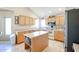 Kitchen with light wood cabinets, center island, and stainless steel appliances at 26028 N 66Th Dr, Phoenix, AZ 85083