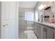 Elegant bathroom with double sinks, granite countertops, and a walk-in shower at 26028 N 66Th Dr, Phoenix, AZ 85083