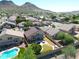 Aerial view showcasing a house with a pool and solar panels; a mountain view in the background at 26028 N 66Th Dr, Phoenix, AZ 85083